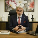 Professional portrait of an international corporate director and legal compliance expert in a modern German office, wearing a business suit